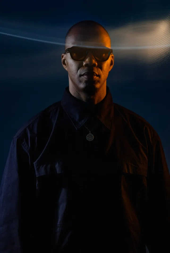 ROWZ JR in dark glasses, an orange light trail across his face